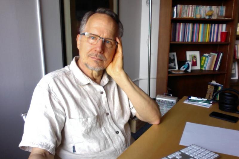 Photograph of Tim Raser at desk