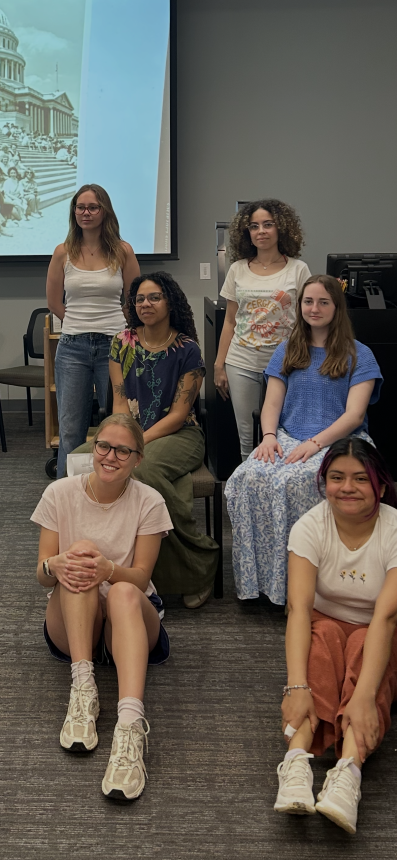 Student research team poses with archival materials