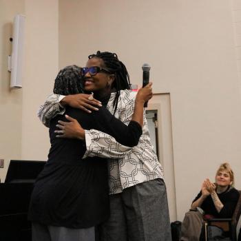 Two women hug each other