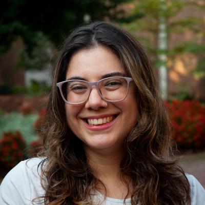 A photo of Laura Vieira, a white woman wearing glasses