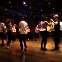 Group dancing Tango in a dimly lit room