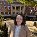 María smiles in front of Gilbert Hall